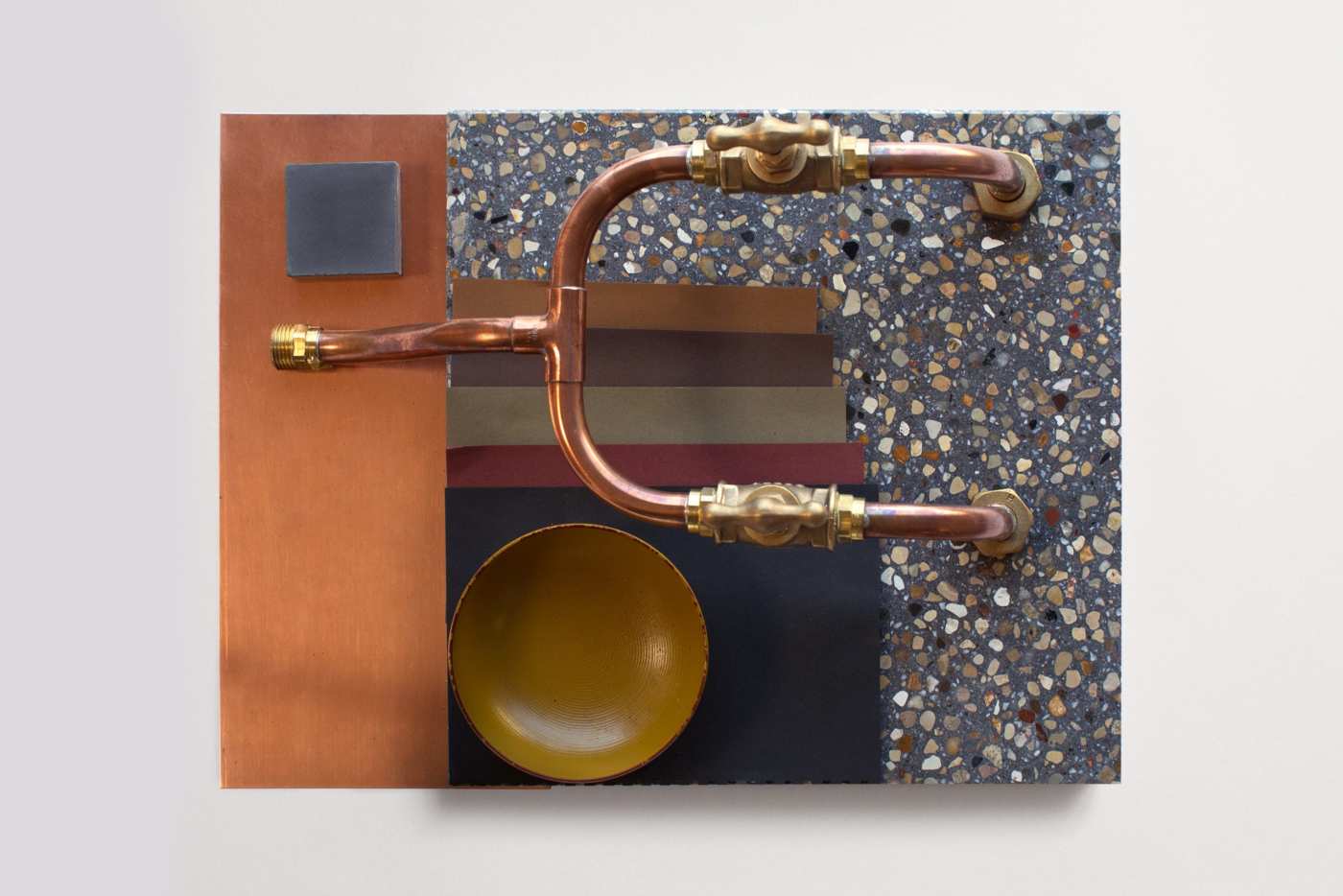 a piece of art with copper pipes and a bowl.