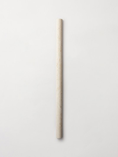 a long wooden stick on a white surface.