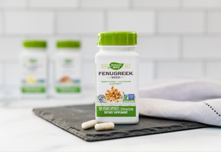 A bottle of Fenugreek Seed sitting on a countertop next to a towel.