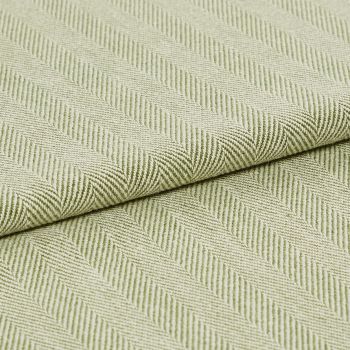 Pale green woven fabric with raised diagonal ribbed herringbone pattern, folded across the frame; the fabric displays pronounced texture and ridges under soft, even studio lighting in a close-up view.