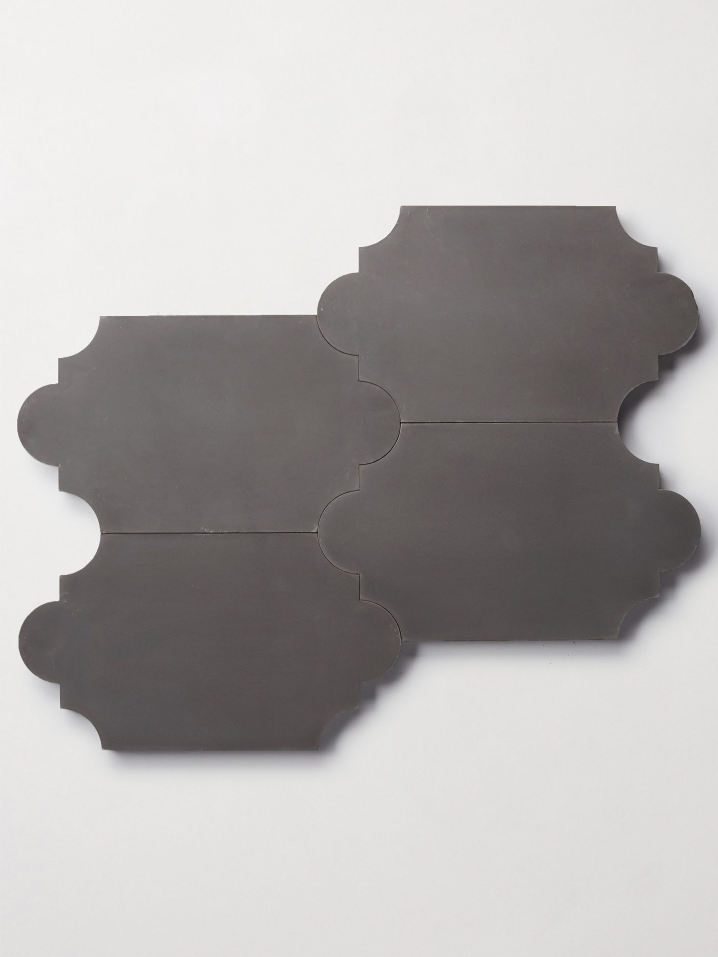 four black lantern shaped tiles on a white surface.