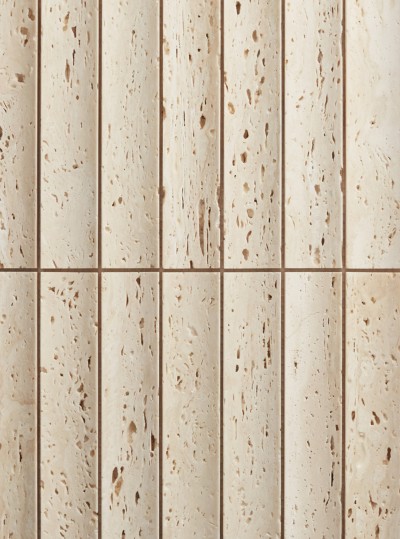 a close up image of a beige tile wall.