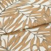 Patterned fabric: folded linen-like textile with overlapping fold. It displays a repeating botanical leaf design in warm tan outlines on a cream background, photographed close-up with soft, even lighting.