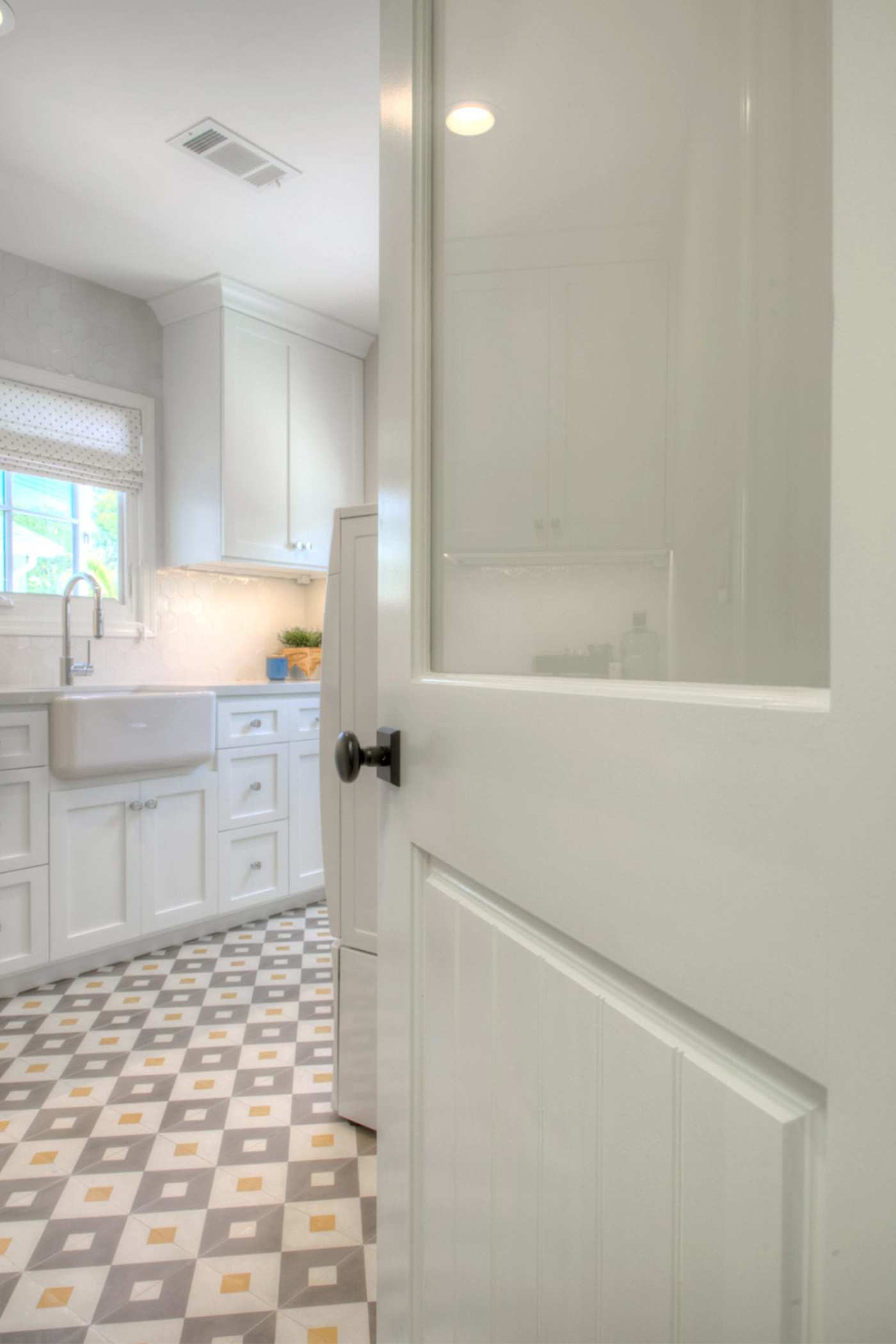 a kitchen with a blue, yellow and white checkered floor.