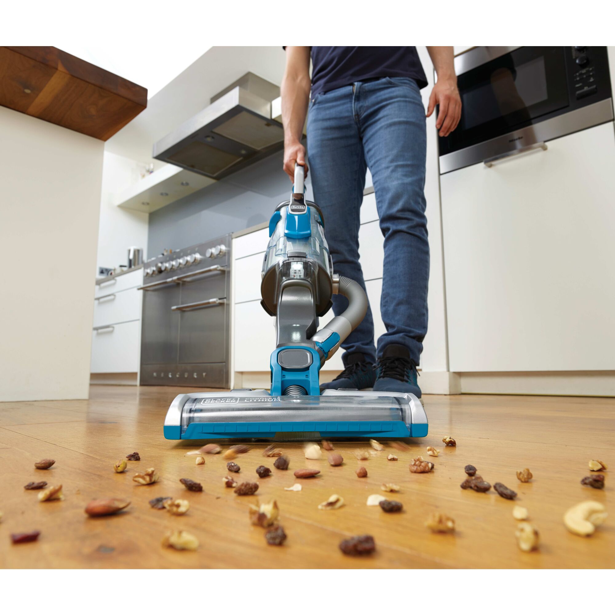 POWER SERIES PRO Cordless 2 in 1 Vacuum being used for cleaning spilled nuts from floor.