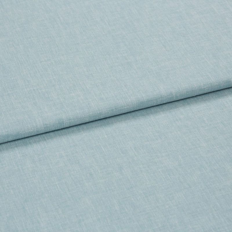 Light-blue linen-like fabric, folded once with an overlapping seam; textured weave visible. Close-up on a flat surface under soft, even studio lighting, neutral background.
