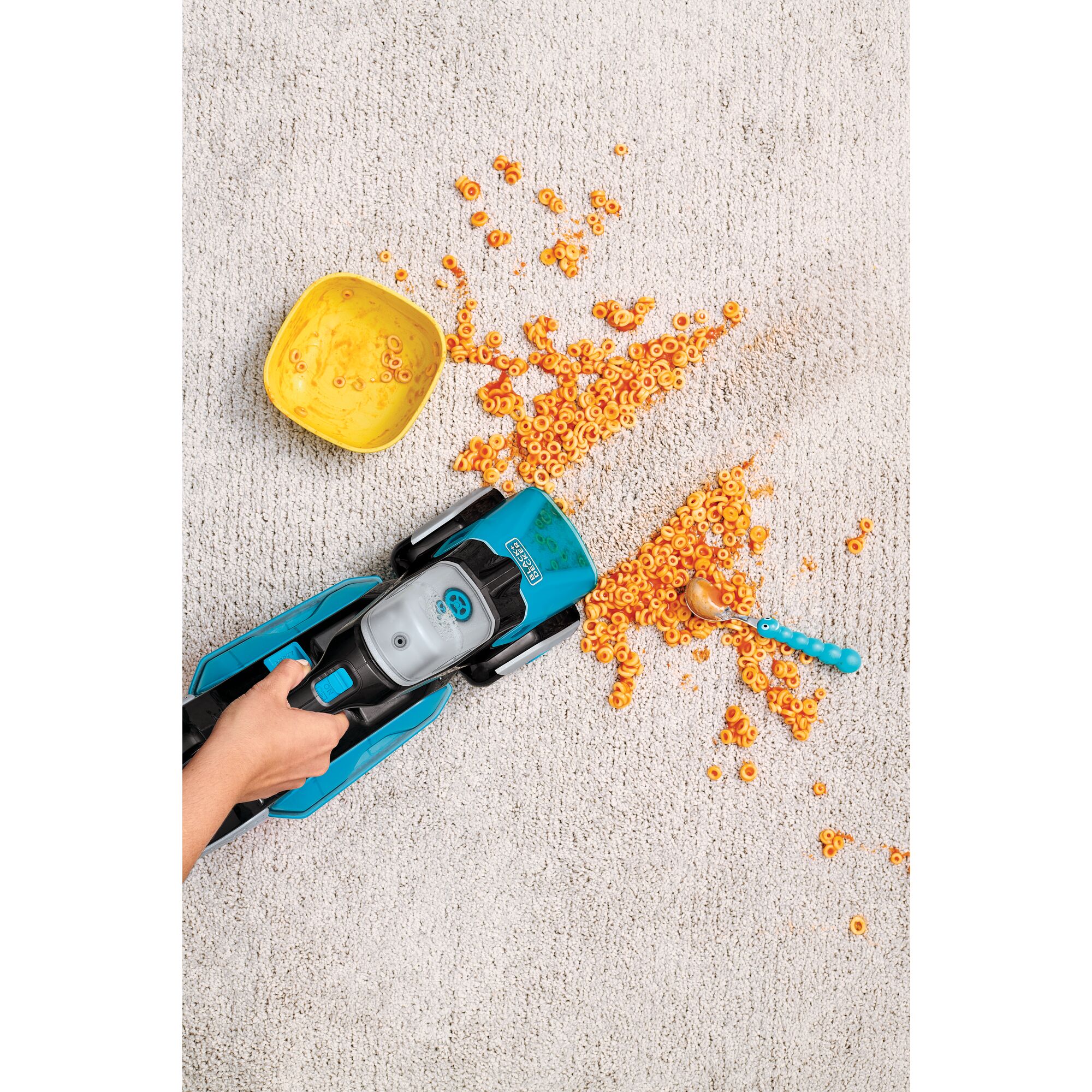 Spillbuster Cordless Spill and Spot Cleaner with Powered Scrub Brush being used to clean spilt food on a carpet.
