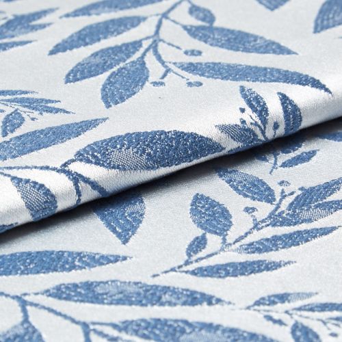 Folded woven fabric with raised blue leaf jacquard pattern; folded and overlapping, revealing textured weave and subtle sheen; close-up product-style shot with soft, neutral lighting suggesting upholstery or curtain material.