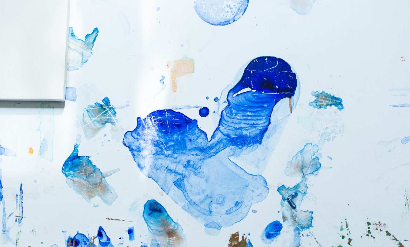 blue paint on a white surface.