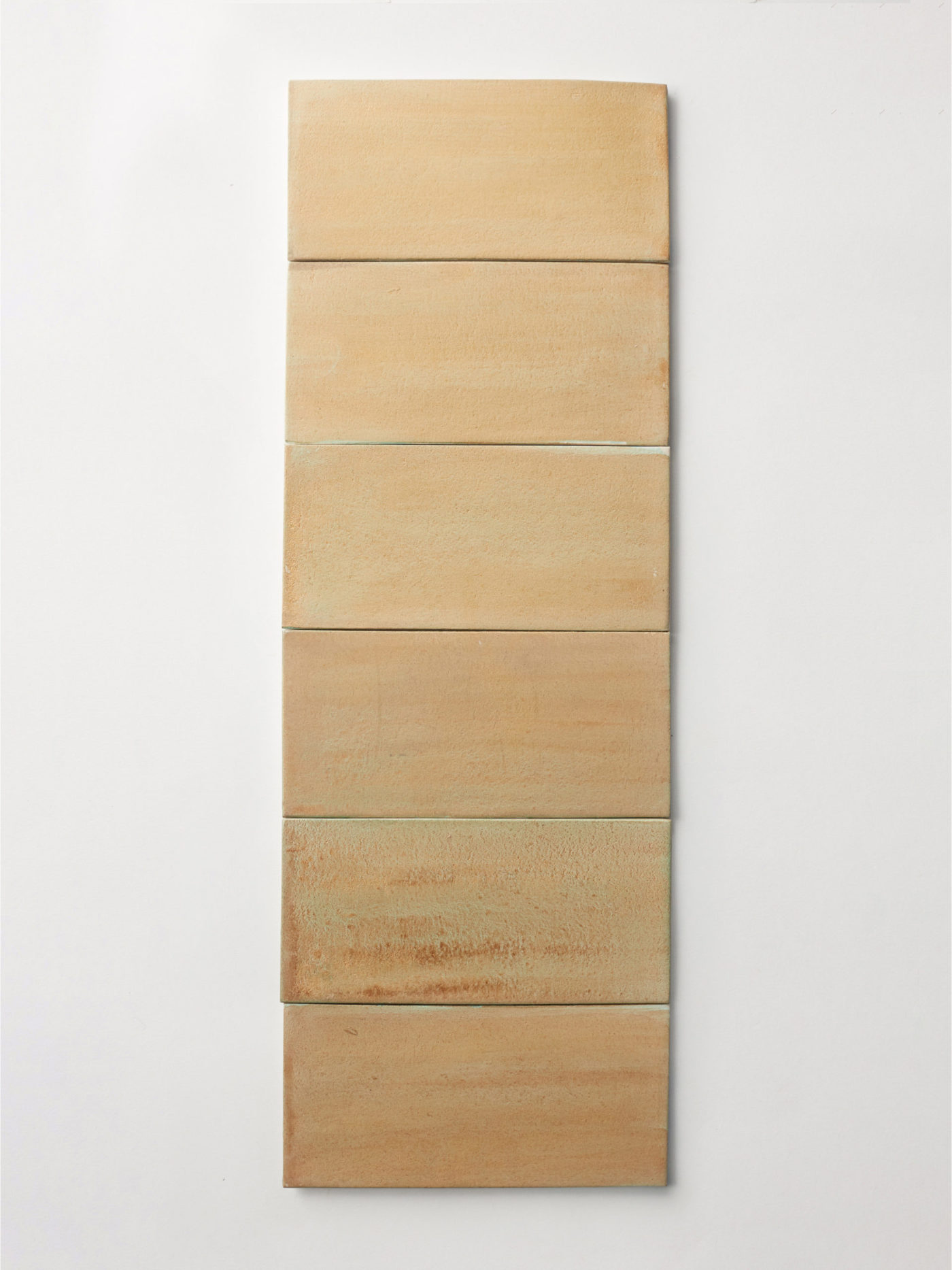 a wooden wall hanging with a beige color.