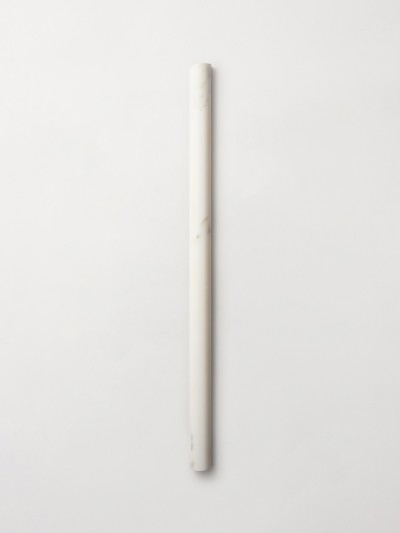 a white marble pencil on a white surface.