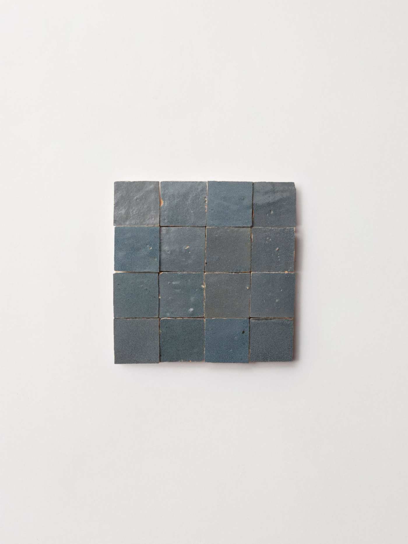 blue tiles arranged on a white surface.