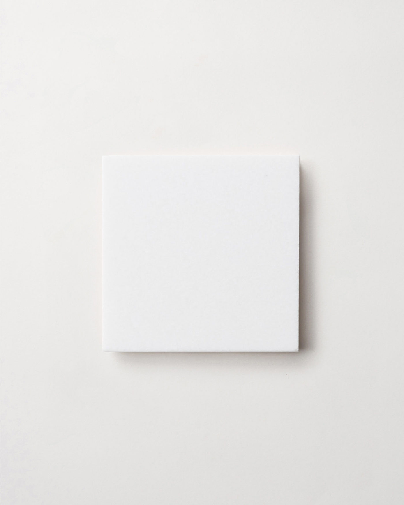 a square white tile on a white background.