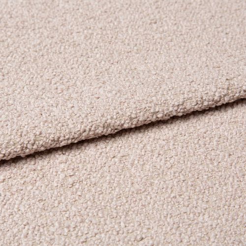 Beige bouclé fabric with dense looped texture, folded over itself forming a soft ridge; close-up studio view of an upholstery/carpet sample under diffuse neutral lighting.