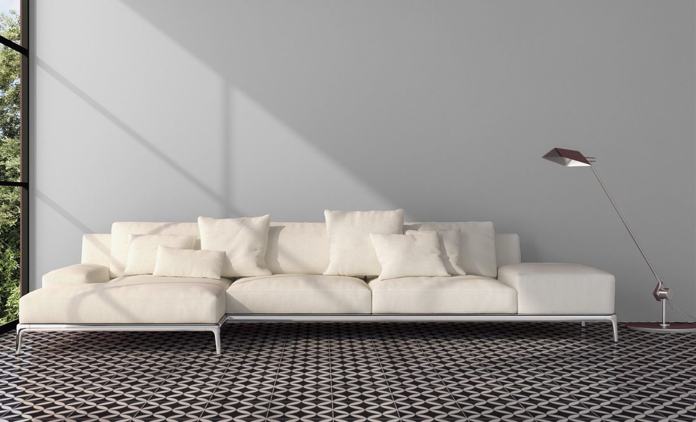 a white sofa in a room with a black and white tiled floor.