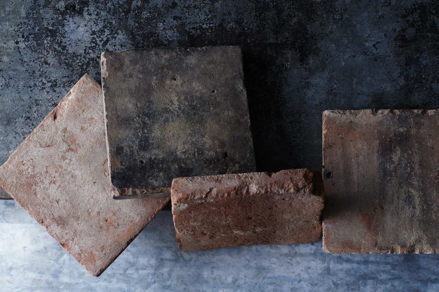 some antique terracotta on a table.