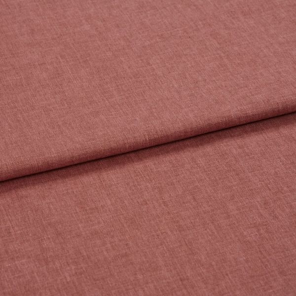 Dusty-rose woven fabric (linen-like), folded once forming a horizontal overlap; textured weave visible, shown in soft diffuse lighting as a close-up flat lay on a neutral surface.