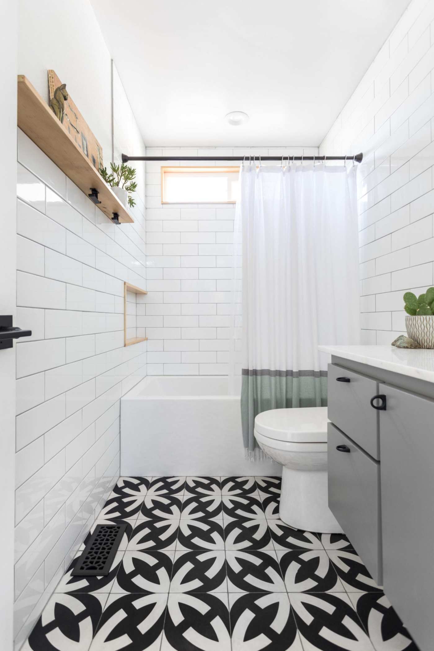 a bathroom with a black and white tile floor.