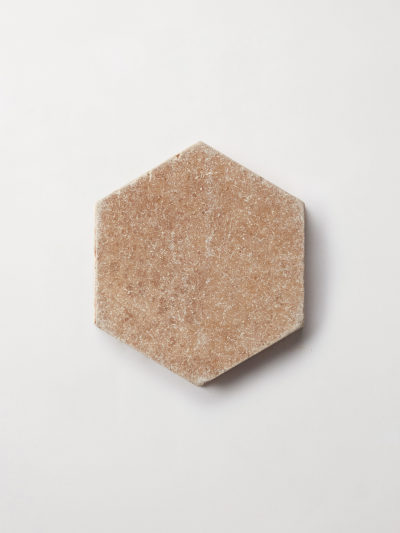 a beige hexagonal tile on a white background.