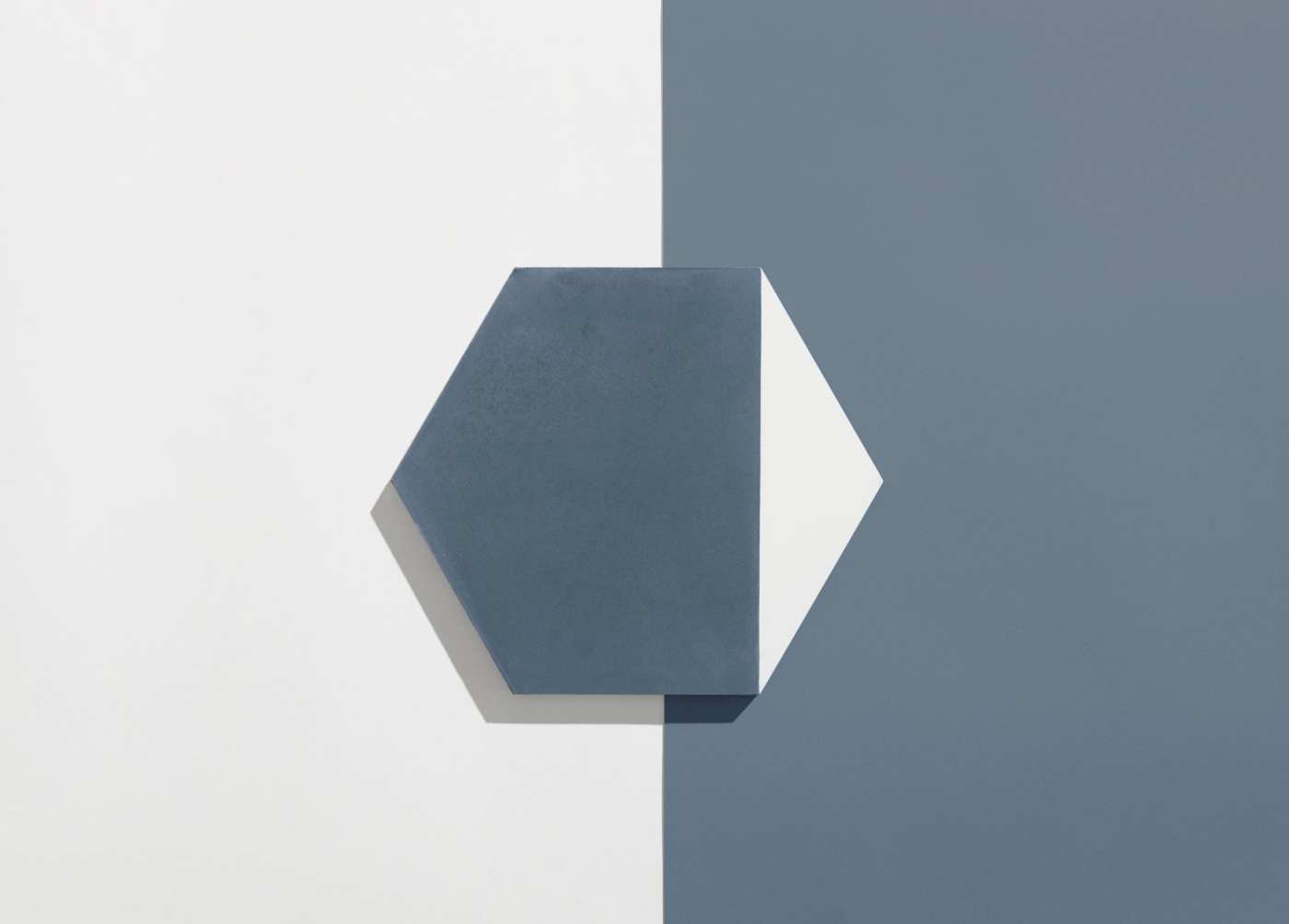 a blue and white hexagonal tile on a white and blue surface.