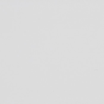 Blank off-white surface shows faint scuffs and tiny specks, evenly lit in a close-up, minimal context with subtle paper- or plaster-like texture.