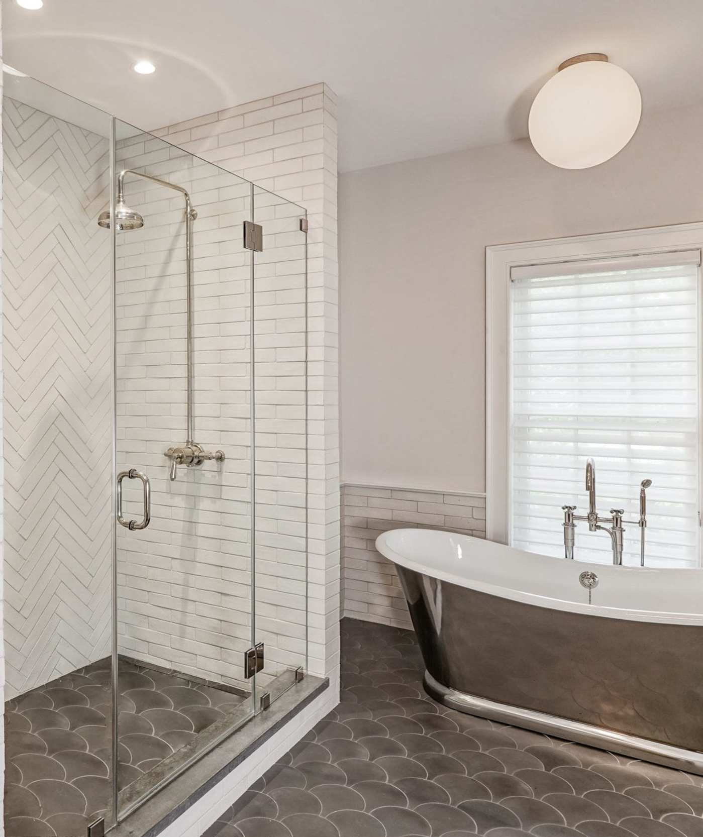 a bathroom with a glass shower stall and a bathtub.