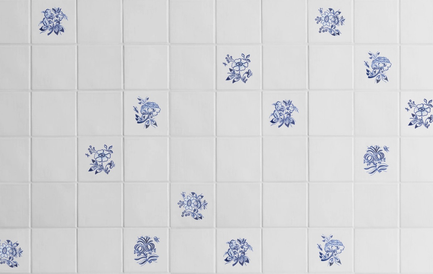 blue and white tiles with hand painted flowers on them.