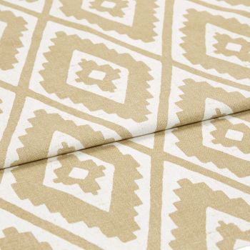 Beige-and-white geometric patterned fabric, folded diagonally to reveal repeating diamond motifs; lying flat with a visible crease, close-up studio view with neutral lighting emphasizing woven texture.