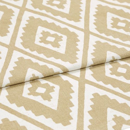 Beige-and-white geometric patterned fabric, folded diagonally to reveal repeating diamond motifs; lying flat with a visible crease, close-up studio view with neutral lighting emphasizing woven texture.