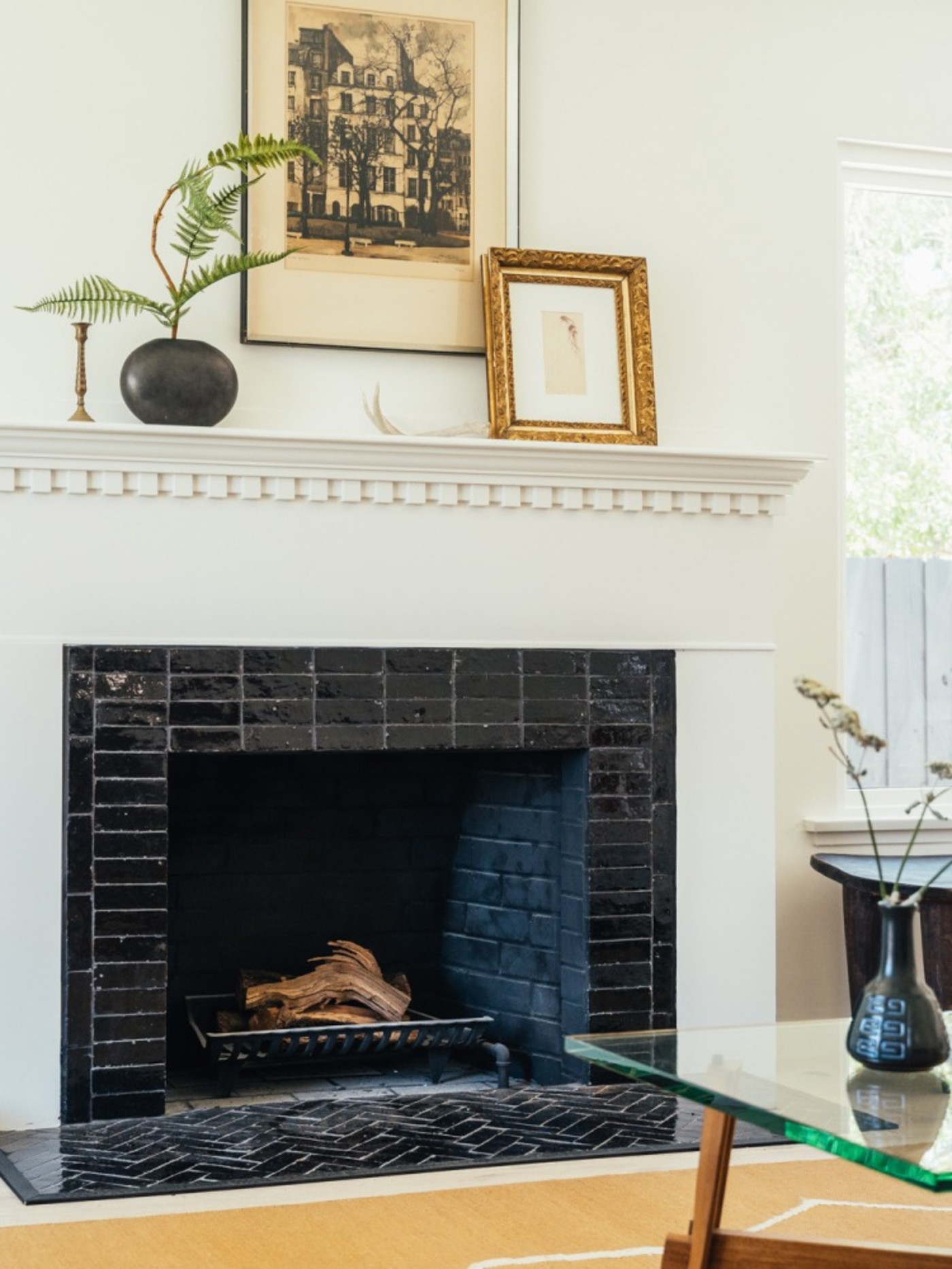 a tiled living room fireplace and a coffee table.