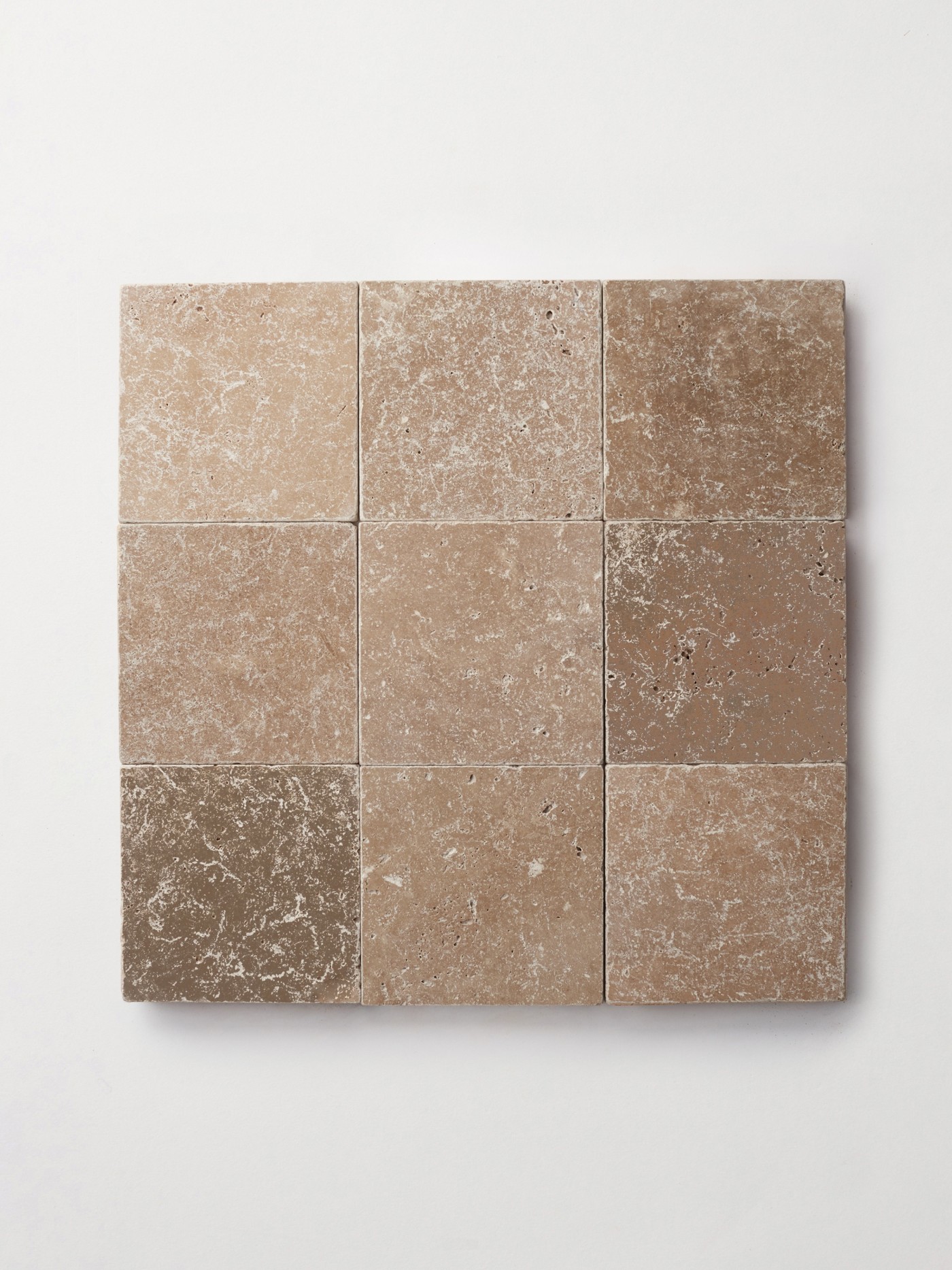 9 square of beige travertine tile on a white background.