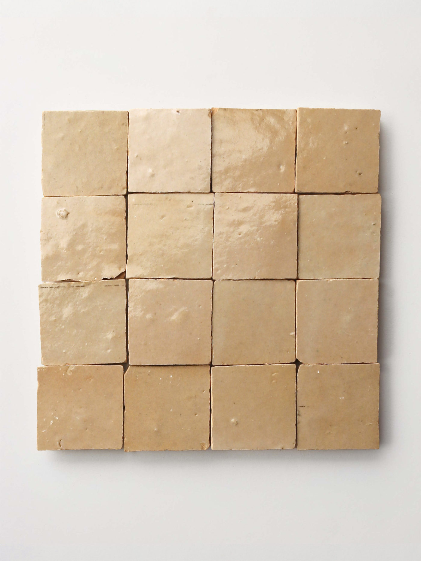 tan tiles arranged on a white surface.