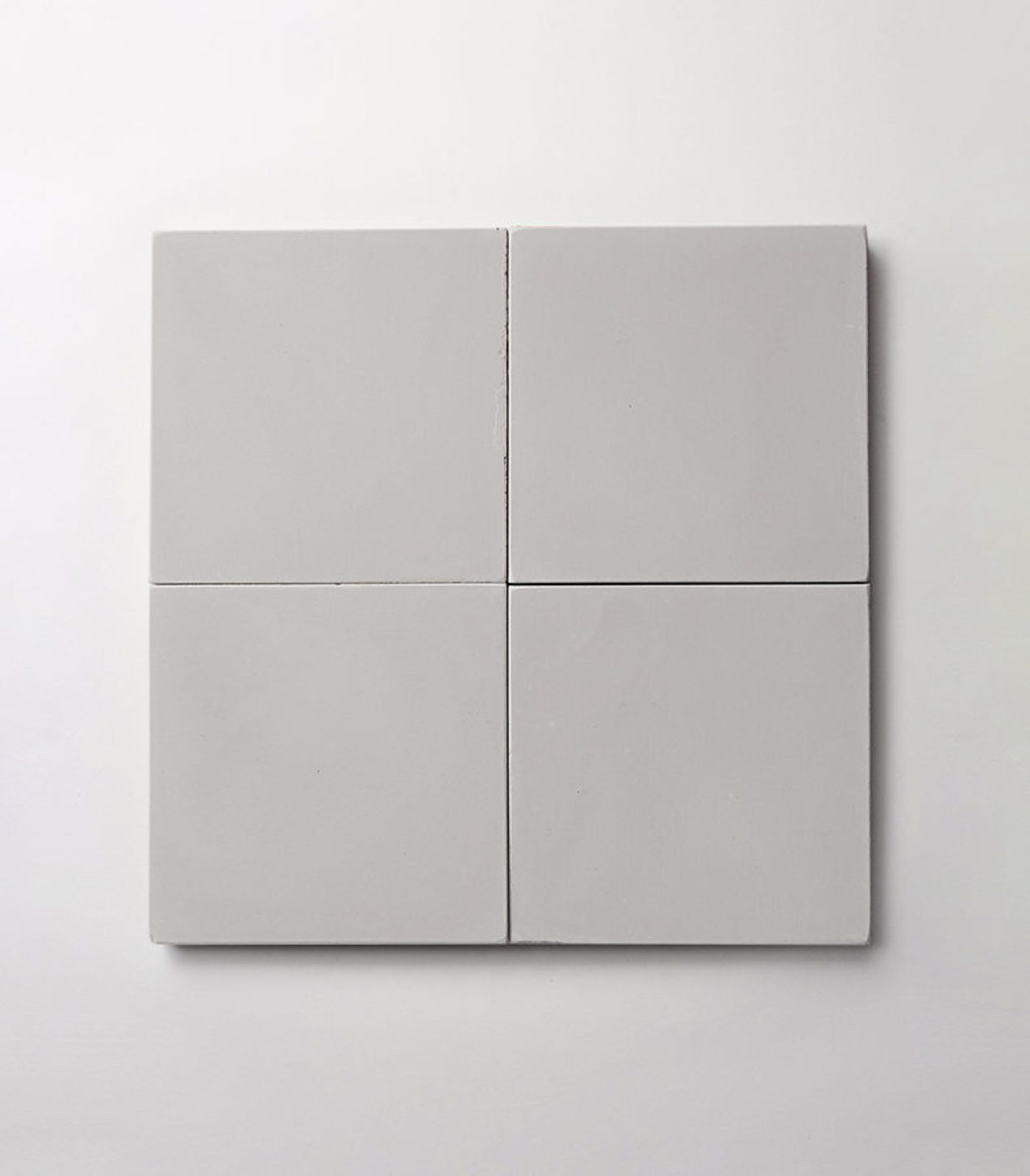 four square grey tiles on a white background.