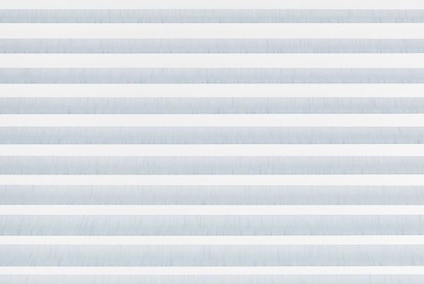 Horizontal zebra blinds with alternating white opaque and pale blue translucent fabric filling the frame, closed and filtering soft daylight, in a minimal interior with no visible view.