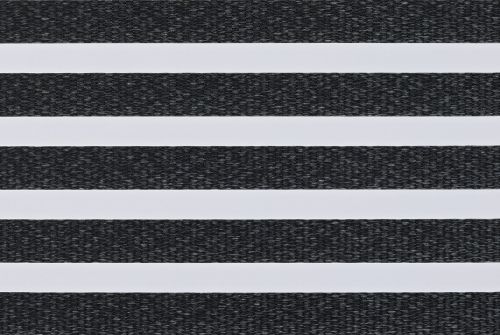 Zebra-style roller blind: alternating opaque white and textured charcoal-gray woven horizontal bands filling the frame; bands aligned to block or filter light in a close-up interior view.