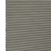 Grey cellular (honeycomb) pleated blind, fully lowered with visible hexagonal side cells, blocking light; close-up view showing textured fabric and narrow horizontal pleats, plain neutral background.