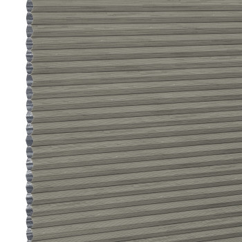 Grey cellular (honeycomb) pleated blind, fully lowered with visible hexagonal side cells, blocking light; close-up view showing textured fabric and narrow horizontal pleats, plain neutral background.