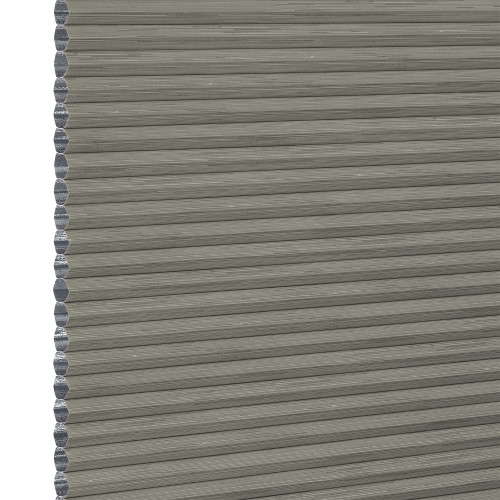 Grey cellular (honeycomb) pleated blind, fully lowered with visible hexagonal side cells, blocking light; close-up view showing textured fabric and narrow horizontal pleats, plain neutral background.