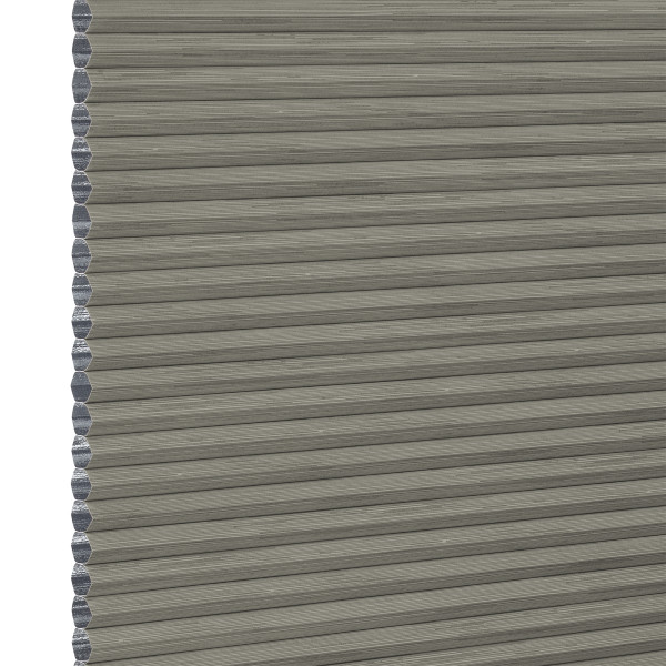 Grey cellular (honeycomb) pleated blind, fully lowered with visible hexagonal side cells, blocking light; close-up view showing textured fabric and narrow horizontal pleats, plain neutral background.