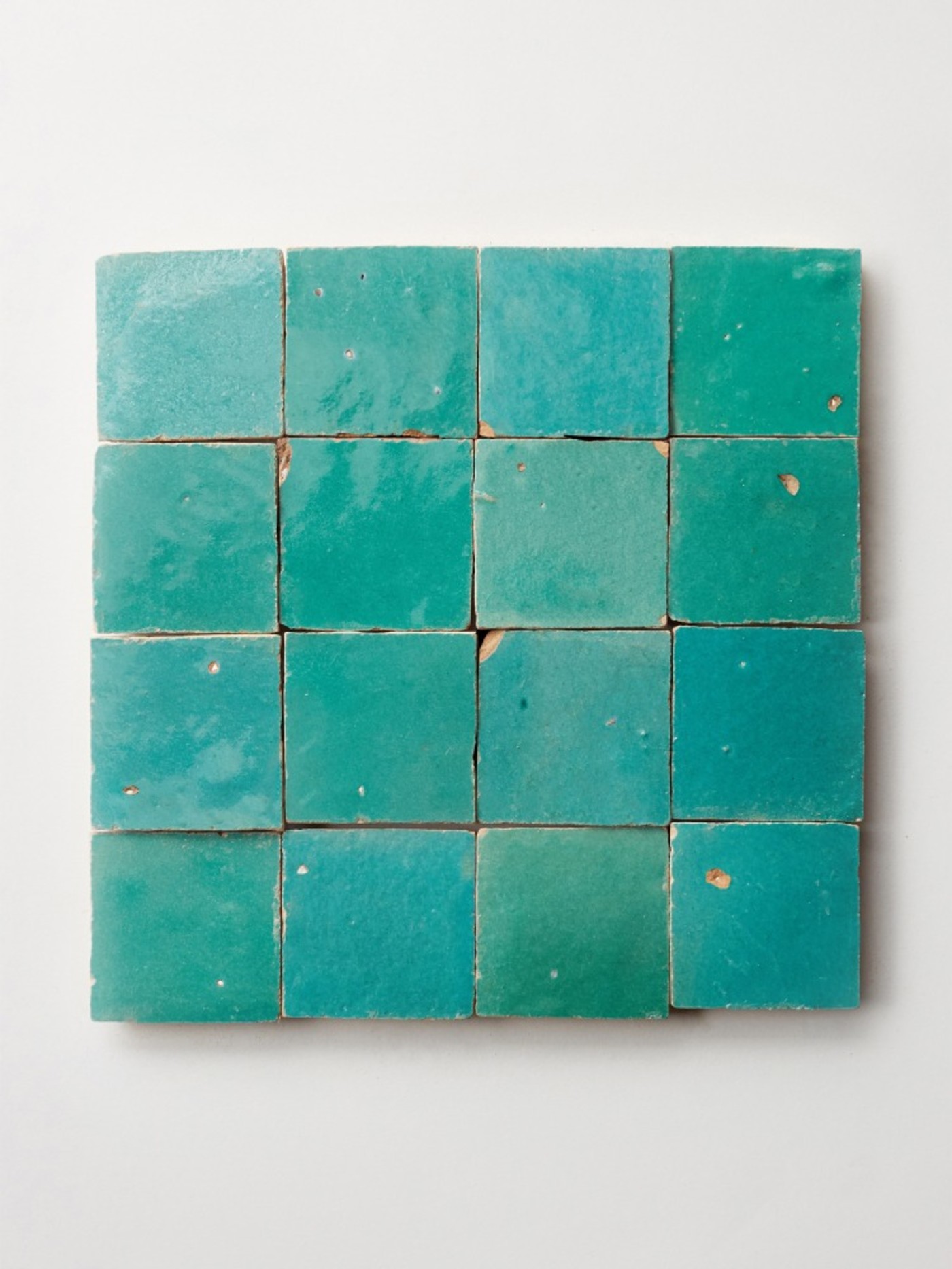 square turquoise tiles on a white background.