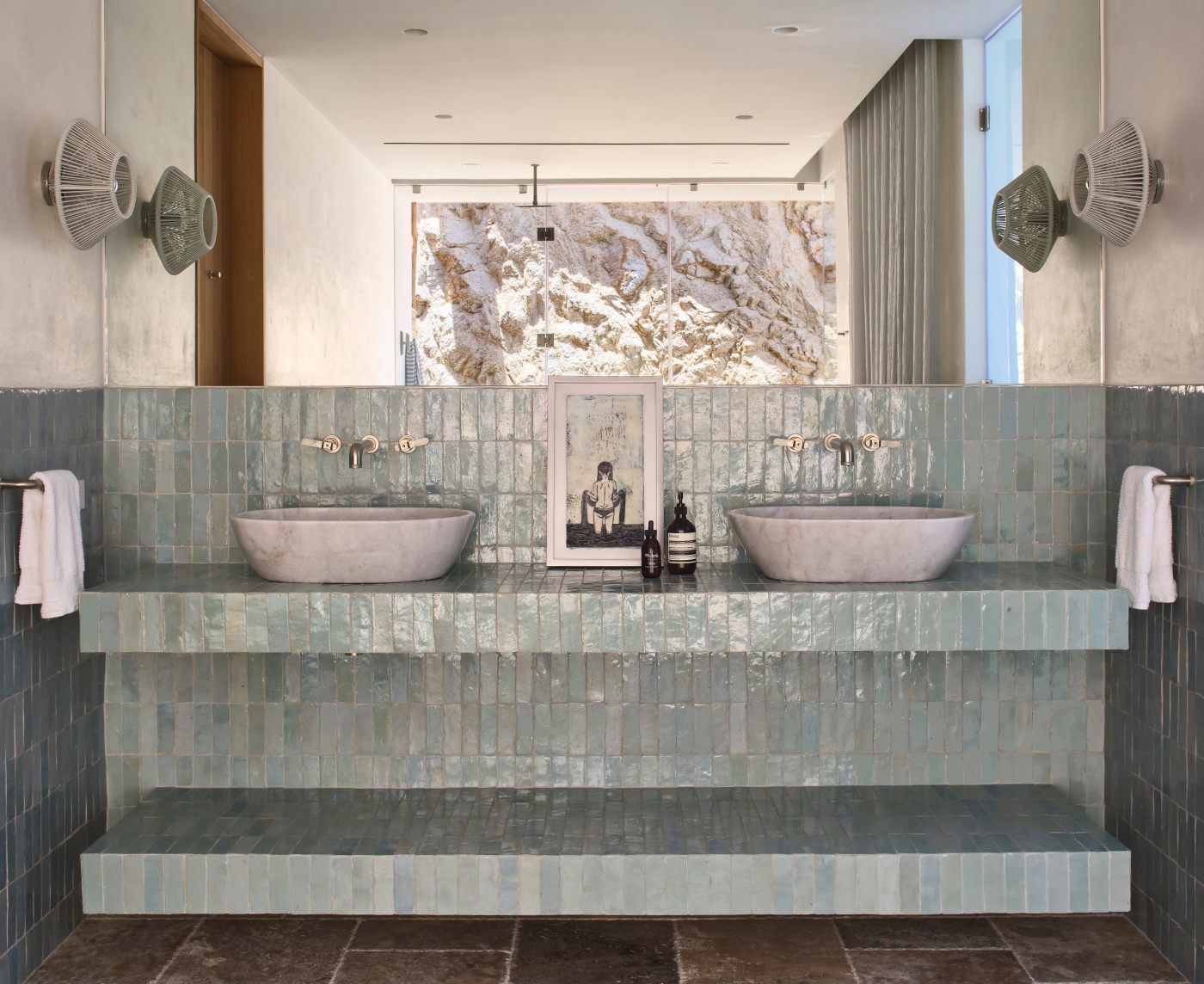 a bathroom with two sinks and a blue tiled counter.