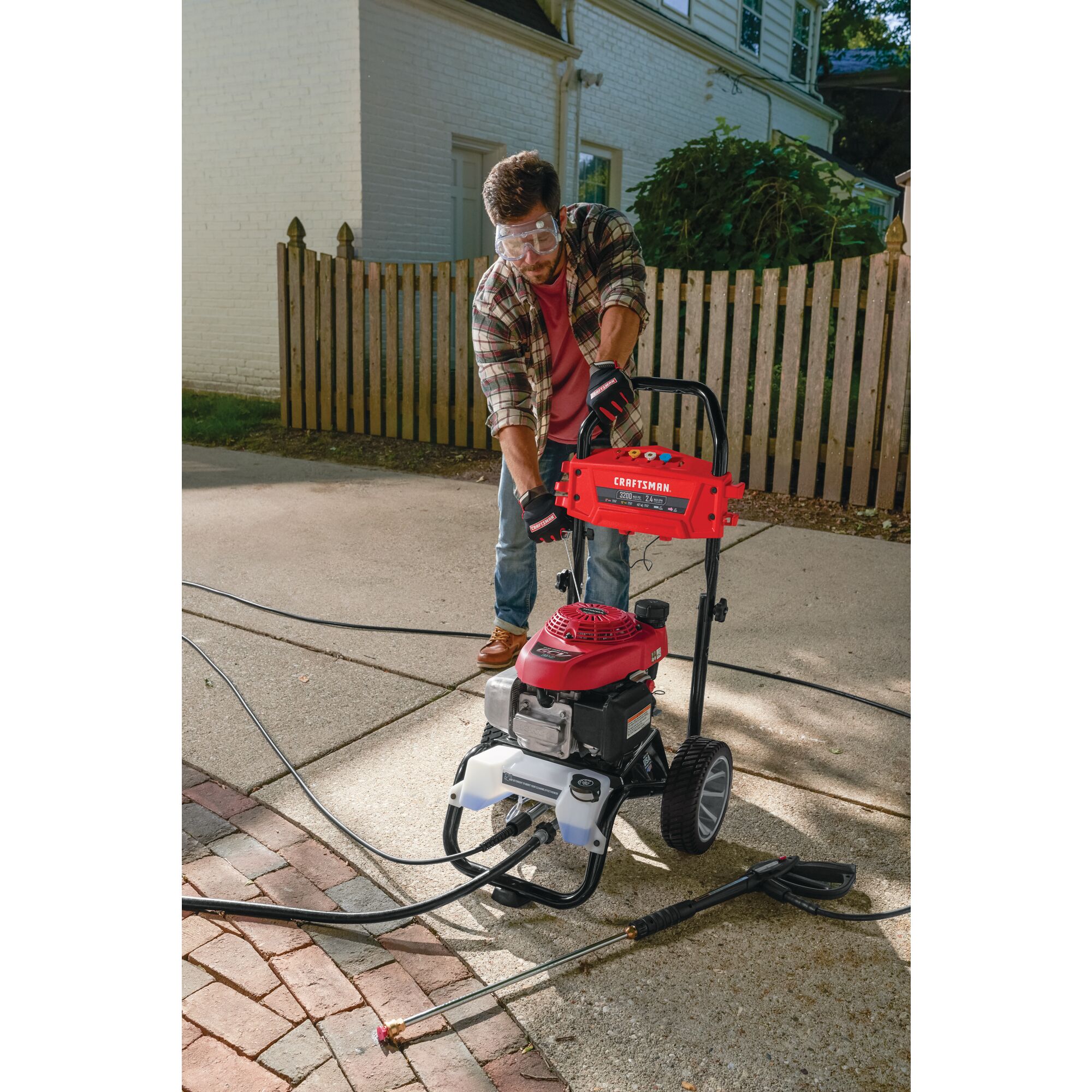 3200 Max P S I / 2.4 max G P M Pressure washer being used by a person to start washer.