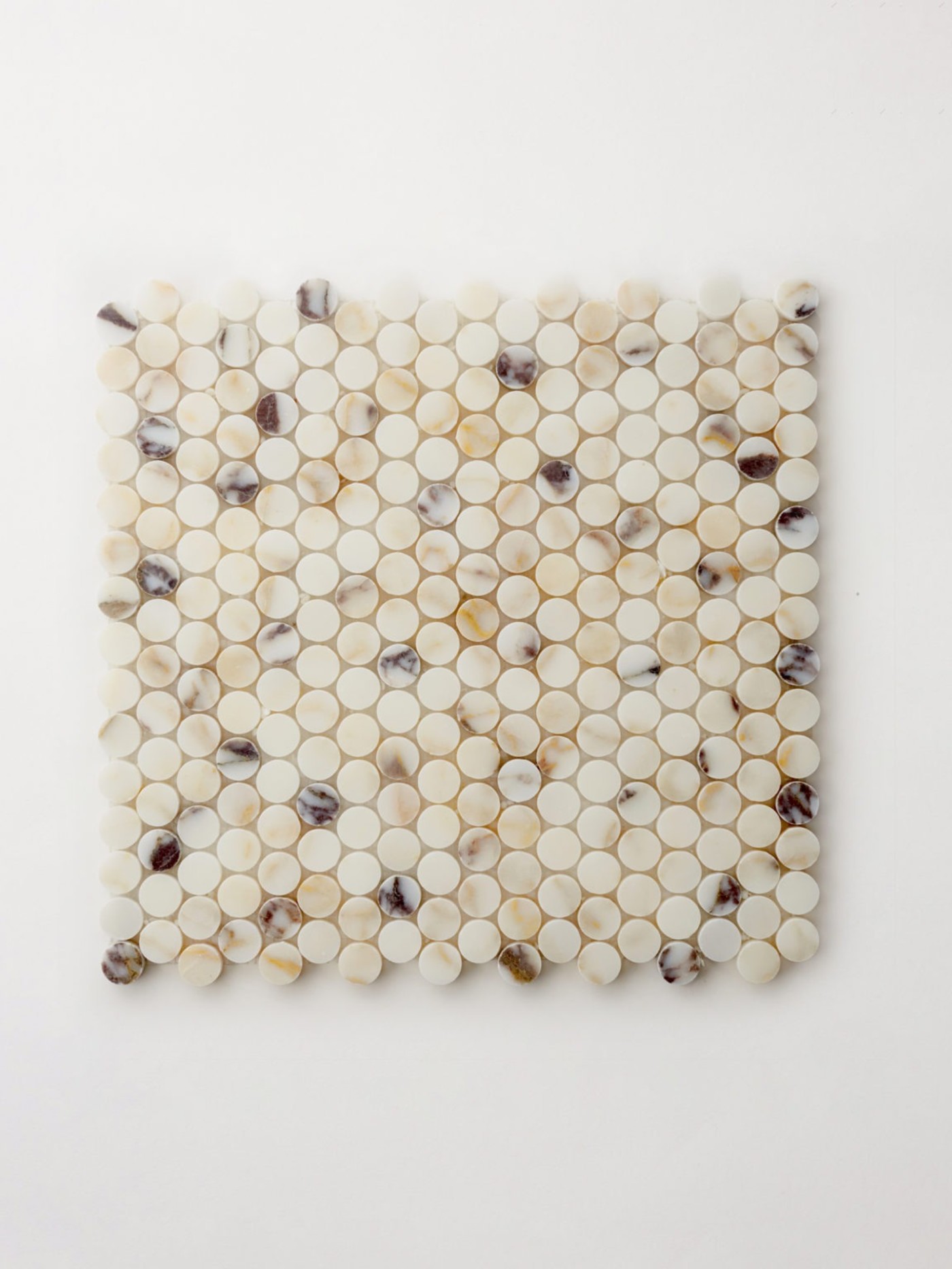 white and brown mosaic tile on a white surface.