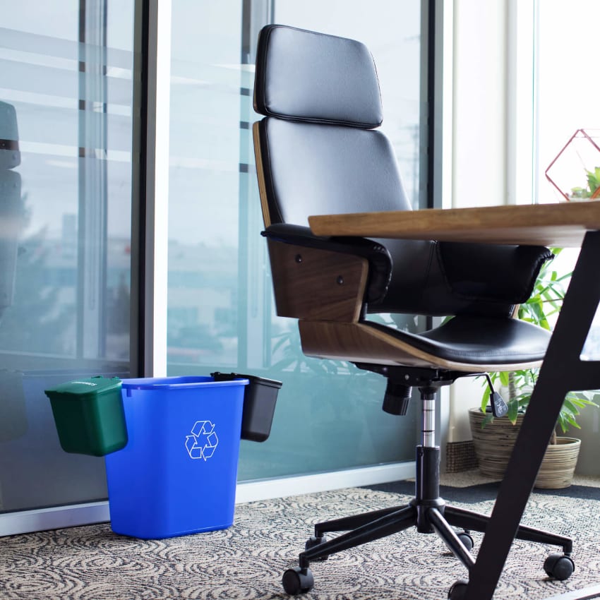 green hanging organics and waste bins on the side of a blue recycling container in a modern office