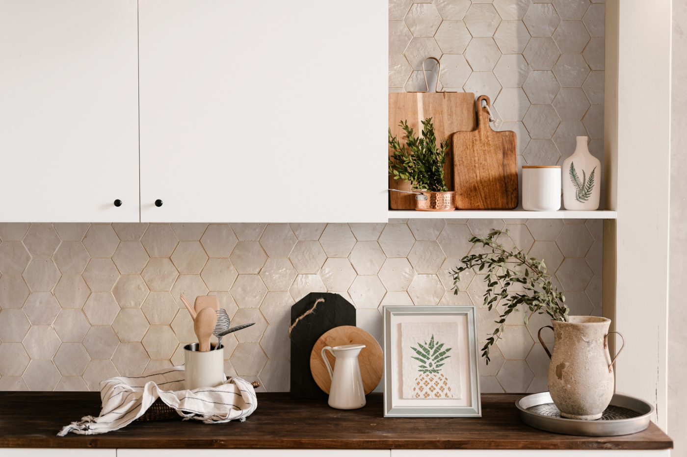 a kitchen with white cabinets and a wooden counter top.