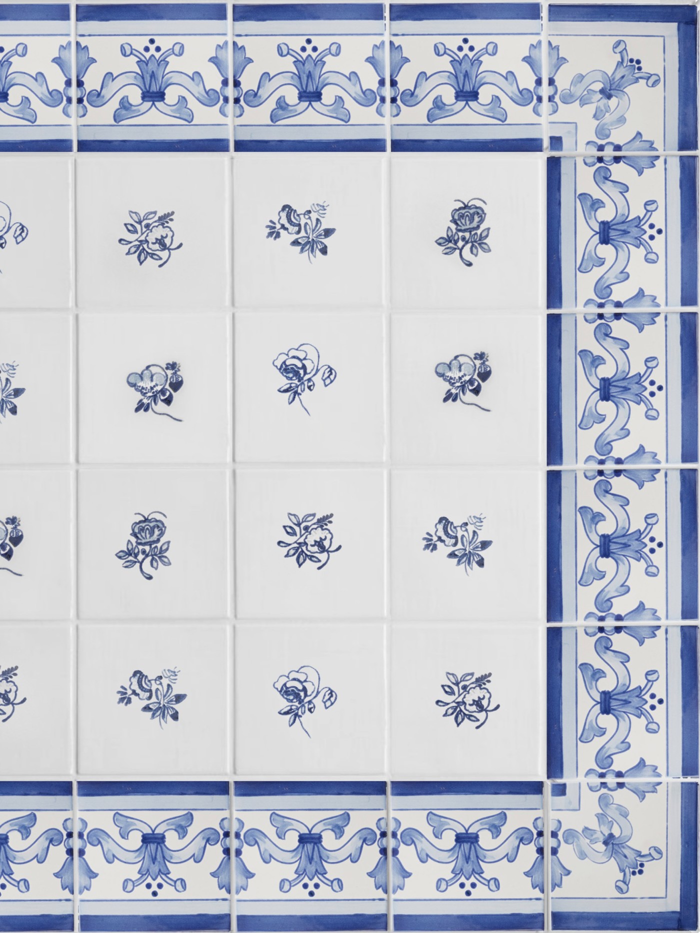 a set of blue and white tiles with floral designs and a border pattern.