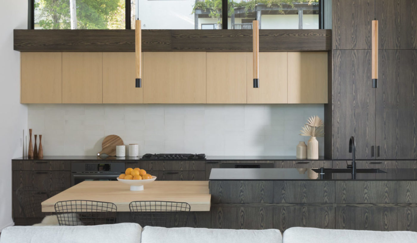 a modern kitchen with wooden cabinets and a wooden island.