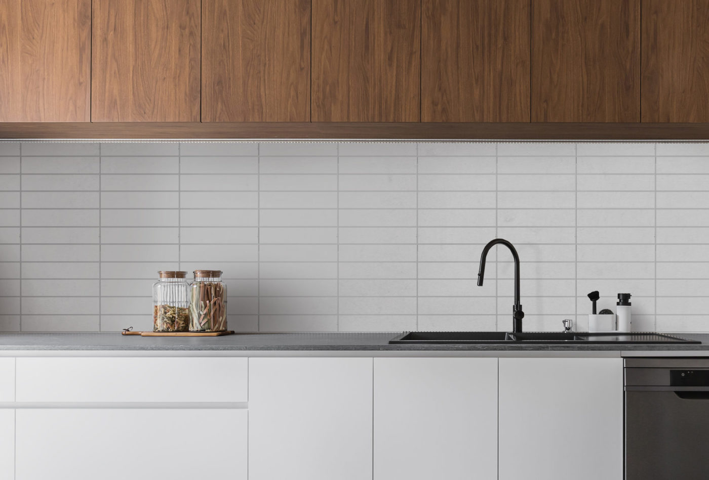 a white kitchen with wooden cabinets and tiled backsplash.