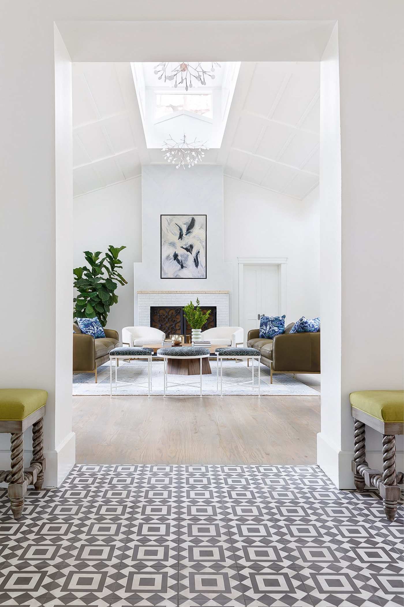 a living room with a fireplace and a tiled floor.