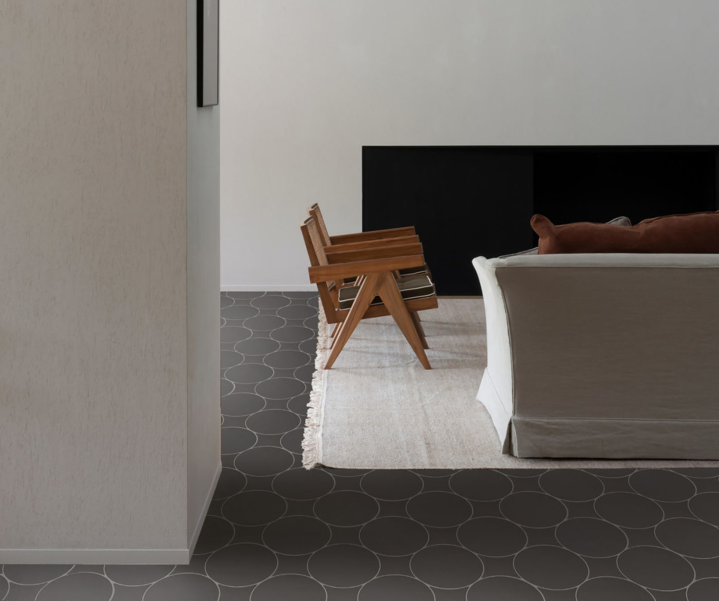 a living room with a couch and a black tile floor.